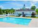 Community clubhouse featuring a sparkling pool and manicured landscaping, perfect for relaxation at 132 Tara Commons Dr, Loganville, GA 30052