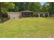 Spacious backyard with a screened porch and mature trees at 1447 High Sierra Dr, Lawrenceville, GA 30043