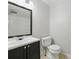 Bright bathroom featuring a vanity sink, toilet, and shower with a glass enclosure at 1447 High Sierra Dr, Lawrenceville, GA 30043