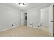 Clean, neutral bedroom with a window, neutral floors, and access to two doorways at 1447 High Sierra Dr, Lawrenceville, GA 30043