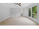 Bright bedroom features tile flooring, a ceiling fan, and large windows offering natural light at 1447 High Sierra Dr, Lawrenceville, GA 30043