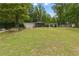 Charming single-story home with a screened porch nestled in a wooded setting on a grassy lot at 1447 High Sierra Dr, Lawrenceville, GA 30043