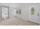 Bright foyer with tile flooring, large window, and a decorative front door leading into the home at 1447 High Sierra Dr, Lawrenceville, GA 30043