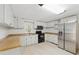 Well-lit kitchen with white cabinets, stainless steel appliances, and laminate countertops at 1447 High Sierra Dr, Lawrenceville, GA 30043