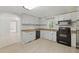Functional kitchen features white cabinets and black appliances at 1447 High Sierra Dr, Lawrenceville, GA 30043