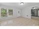 Bright living room with tile flooring, large window, and white front door at 1447 High Sierra Dr, Lawrenceville, GA 30043