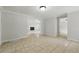 Open-concept living room with tile flooring and a glimpse of the living room with a fireplace at 1447 High Sierra Dr, Lawrenceville, GA 30043