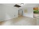 Bright living room with neutral paint, tile floors, and an access door to the outdoor deck at 1447 High Sierra Dr, Lawrenceville, GA 30043