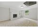 Bright living room featuring a painted brick fireplace and tile floors at 1447 High Sierra Dr, Lawrenceville, GA 30043