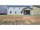 Backyard of a two-story home with a covered patio and large yard at 2436 Cadenza Cir, Dacula, GA 30019