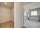 Bright bathroom featuring a standalone tub, white marble tile and a walk-in closet at 2436 Cadenza Cir, Dacula, GA 30019