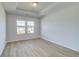 Bedroom showcasing two windows bringing in natural light and a tray ceiling at 2436 Cadenza Cir, Dacula, GA 30019