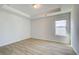 The bedroom shows a window bringing in natural light and neutral paint on the walls at 2436 Cadenza Cir, Dacula, GA 30019