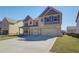 Attractive two-story brick home featuring a double garage and a neatly landscaped front yard at 2436 Cadenza Cir, Dacula, GA 30019