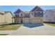 Beautiful two-story home with a spacious driveway, brick exterior, and well-maintained lawn at 2436 Cadenza Cir, Dacula, GA 30019