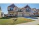Inviting two-story house showcasing a brick facade, double garage, and green front lawn at 2436 Cadenza Cir, Dacula, GA 30019