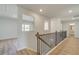 Hallway with natural light and wood floors showcasing the layout of the upper level at 2436 Cadenza Cir, Dacula, GA 30019