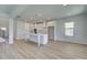 Bright and airy kitchen with white cabinets, a center island, and hardwood floors, open floor plan at 2436 Cadenza Cir, Dacula, GA 30019