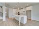A modern kitchen with white cabinets, a large island, and pendant lighting at 2436 Cadenza Cir, Dacula, GA 30019