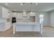 Contemporary kitchen featuring a center island, sleek white cabinets, and modern pendant lights at 2436 Cadenza Cir, Dacula, GA 30019