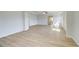 Open-concept living room with natural light, wood floors, and a bathroom nearby at 2436 Cadenza Cir, Dacula, GA 30019