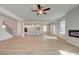 Living room features a modern fireplace, wood floors and an open-concept kitchen at 2436 Cadenza Cir, Dacula, GA 30019