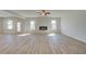 Living room with a modern fireplace, wood floors, and lots of natural light at 2436 Cadenza Cir, Dacula, GA 30019