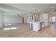 Spacious open floor plan with wood floors, connects the living room and kitchen at 2436 Cadenza Cir, Dacula, GA 30019