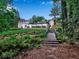 Picturesque backyard showcasing lush landscaping, a charming bridge, and architectural details at 3625 Tuxedo Nw Rd, Atlanta, GA 30305