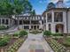 Beautifully landscaped backyard with stone walkway, manicured garden beds, and elegant architectural details at 3625 Tuxedo Nw Rd, Atlanta, GA 30305