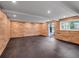 Basement with wood paneling and rubber flooring, featuring a door to the outside at 3625 Tuxedo Nw Rd, Atlanta, GA 30305
