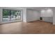 Bright basement with hardwood flooring, bar, and expansive window view of landscaped yard at 3625 Tuxedo Nw Rd, Atlanta, GA 30305