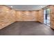 Basement featuring wood paneling, rubber flooring, and access to outside at 3625 Tuxedo Nw Rd, Atlanta, GA 30305