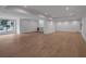 Spacious basement featuring hardwood floors, a bar area, and natural light from a large window at 3625 Tuxedo Nw Rd, Atlanta, GA 30305
