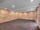 Finished basement with wood paneled walls, rubber floor and walk out to exterior at 3625 Tuxedo Nw Rd, Atlanta, GA 30305
