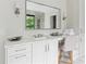 Bathroom vanity with white cabinets, marble countertop, a large mirror, and a sink with chrome fixtures at 3625 Tuxedo Nw Rd, Atlanta, GA 30305