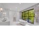 Bright bathroom with a marble-style soaking tub and expansive backyard view at 3625 Tuxedo Nw Rd, Atlanta, GA 30305