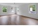 Large bright bedroom features hardwood floors, white trim, and three windows overlooking the exterior at 3625 Tuxedo Nw Rd, Atlanta, GA 30305