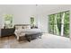 Inviting bedroom featuring a large picture window with backyard view, a plush bed, and elegant decor at 3625 Tuxedo Nw Rd, Atlanta, GA 30305