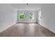 Large bright bedroom features hardwood floors, white trim, and three windows overlooking the exterior at 3625 Tuxedo Nw Rd, Atlanta, GA 30305