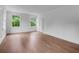 Bright bedroom features hardwood floors, white trim, and two windows overlooking the landscaped exterior at 3625 Tuxedo Nw Rd, Atlanta, GA 30305
