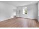Bright bedroom features hardwood floors, white trim, and a window overlooking the landscaped exterior at 3625 Tuxedo Nw Rd, Atlanta, GA 30305