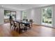 Bright dining room with hardwood floors, large windows, and a modern table set for six at 3625 Tuxedo Nw Rd, Atlanta, GA 30305