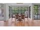 Dining room with floor to ceiling windows offering natural light and wooden floors at 3625 Tuxedo Nw Rd, Atlanta, GA 30305