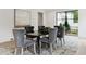 Formal dining room featuring a modern table, stylish chairs, and a view of the outdoors at 3625 Tuxedo Nw Rd, Atlanta, GA 30305