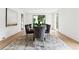 Bright dining room features hardwood floors, modern rug, and large window with backyard view at 3625 Tuxedo Nw Rd, Atlanta, GA 30305