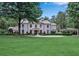 Beautiful home featuring a sprawling lawn, mature trees, and a charming porte-cochere at 3625 Tuxedo Nw Rd, Atlanta, GA 30305