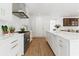 Spacious kitchen featuring white cabinetry, stainless steel appliances, and light hardwood flooring at 3625 Tuxedo Nw Rd, Atlanta, GA 30305
