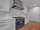 Custom kitchen with marble backsplash, stainless steel appliances, and a bold blue and gold range at 3625 Tuxedo Nw Rd, Atlanta, GA 30305