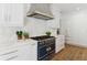 Well-equipped kitchen with marble backsplash, stainless appliances, and light colored cabinetry at 3625 Tuxedo Nw Rd, Atlanta, GA 30305